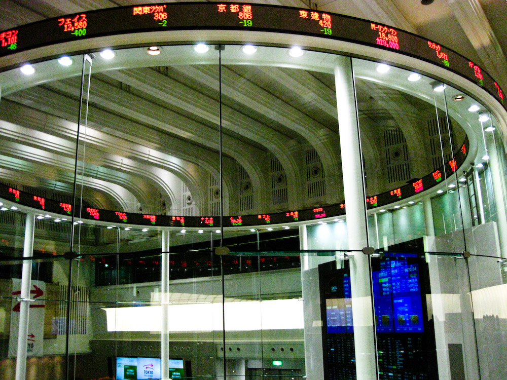 Stock exchange trading floor with a digital ticker display